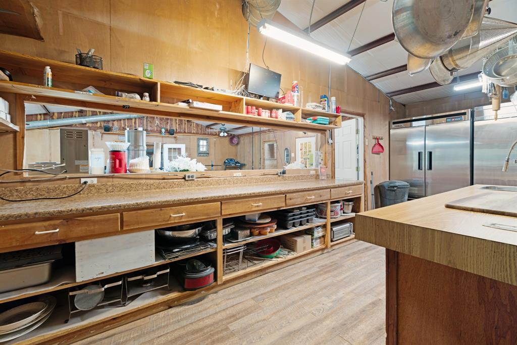 3178 East 2150 Road Grant, OK 74738 - Photo 28 of 40 a kitchen with stainless steel appliances granite countertop a lot of counter space and wooden floors