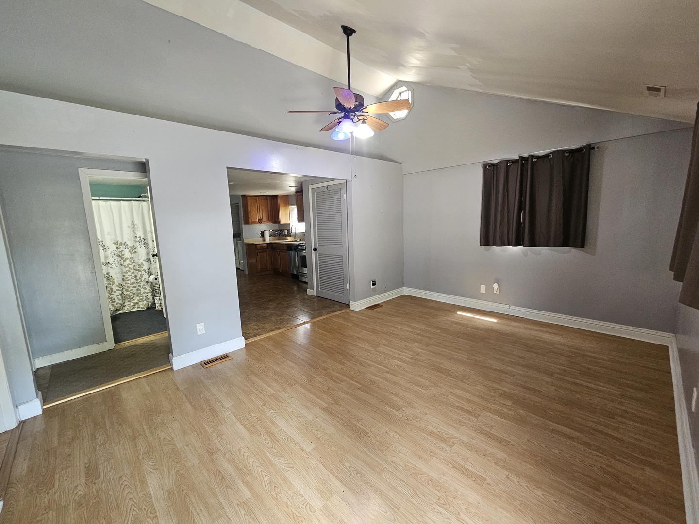 10N827 Hawthorne Street Elgin, IL 60123 - Photo 5 of 14 a view of a livingroom with wooden floor and a ceiling fan