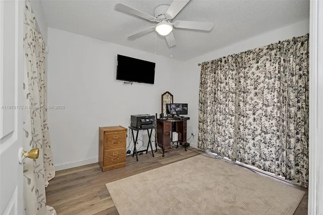 a view of a workspace with furniture and a flat screen tv