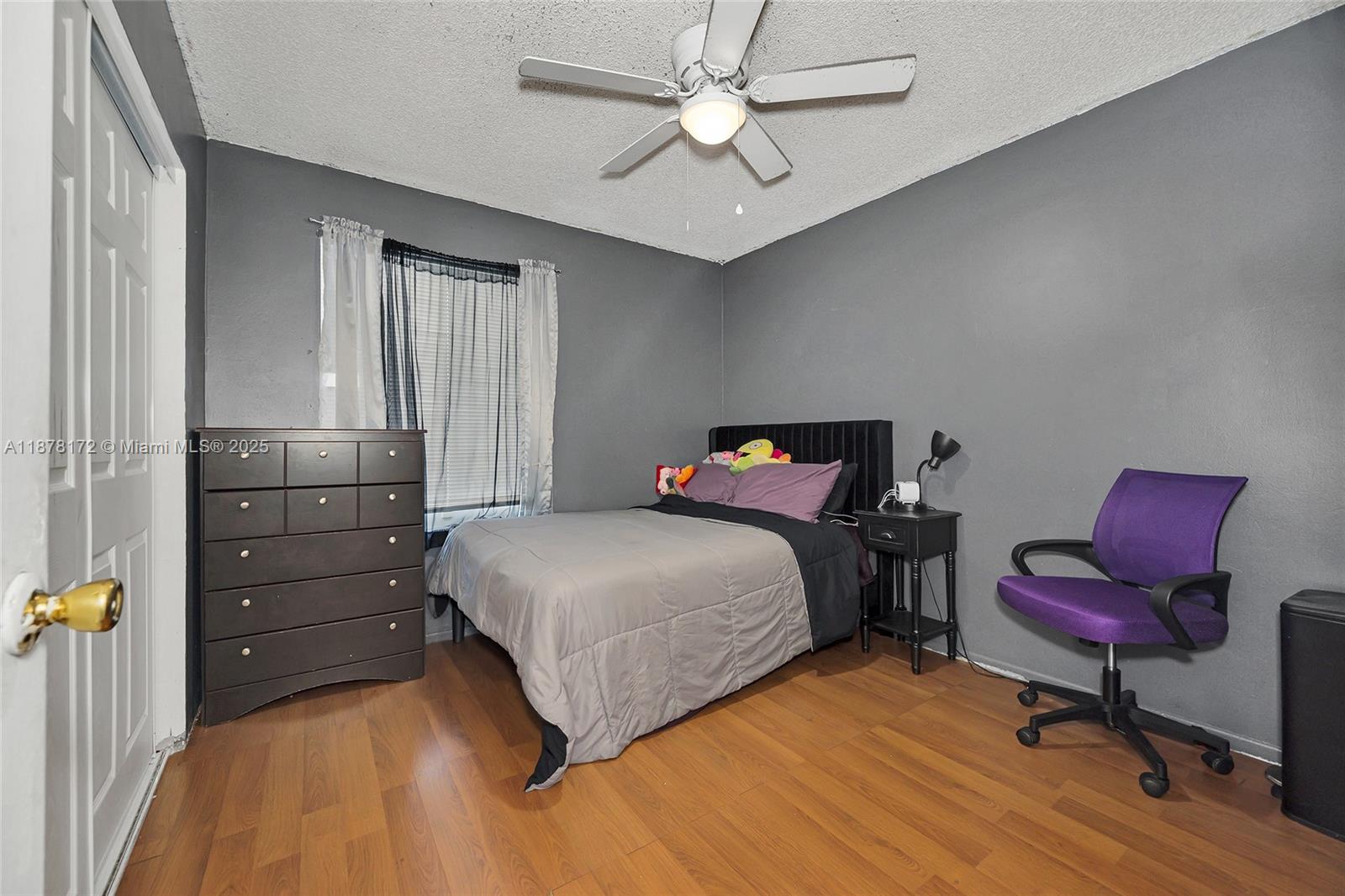 1720 Southwest 84th Avenue Miramar, FL 33025 - Photo 15 of 30 a bedroom with a bed and a dresser in it