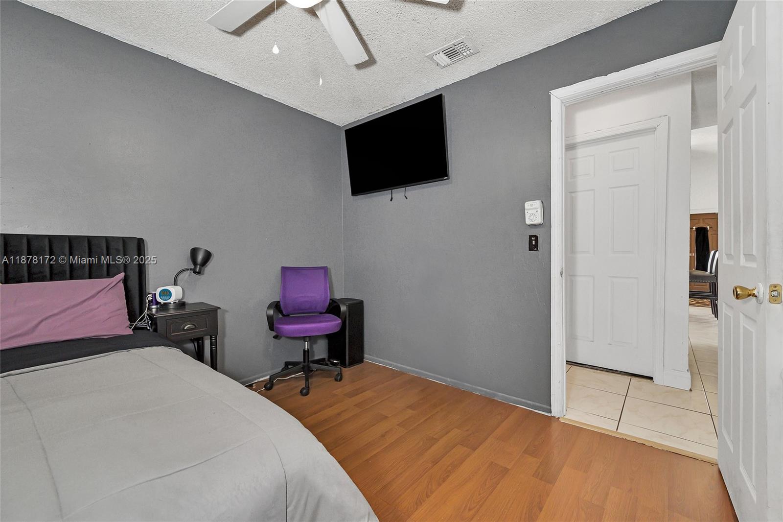 1720 Southwest 84th Avenue Miramar, FL 33025 - Photo 16 of 30 a bedroom with a bed and a flat screen tv