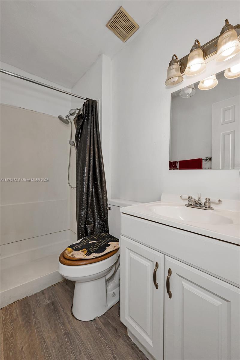 1720 Southwest 84th Avenue Miramar, FL 33025 - Photo 19 of 30 a bathroom with a sink a toilet and a mirror