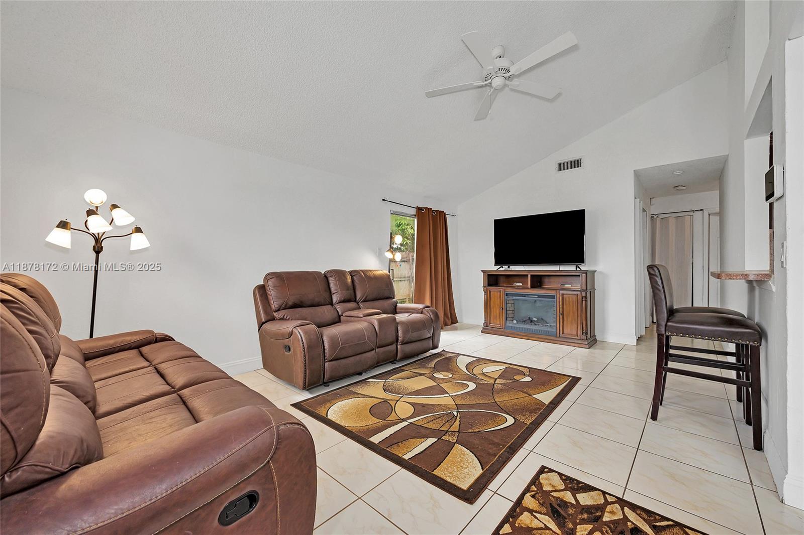 1720 Southwest 84th Avenue Miramar, FL 33025 - Photo 2 of 30 a living room with furniture and a flat screen tv