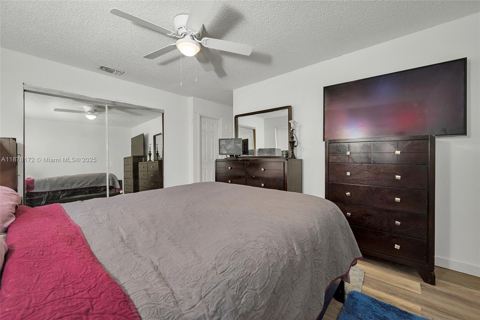 1720 Southwest 84th Avenue Miramar, FL 33025 - Photo 21 of 30 a spacious bedroom with a bed and a flat screen tv