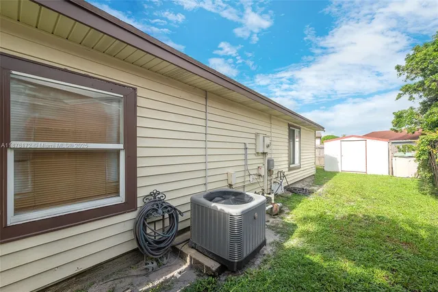 a backyard of a house with table and chairs