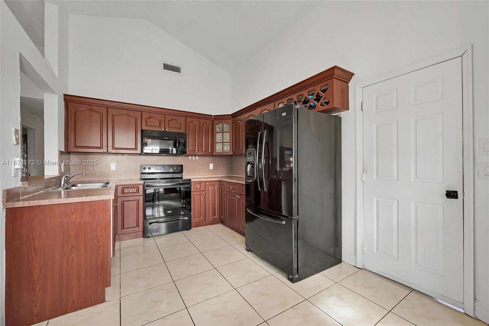 1720 Southwest 84th Avenue Miramar, FL 33025 - Photo 5 of 30 a kitchen with stainless steel appliances granite countertop a refrigerator and a stove top oven
