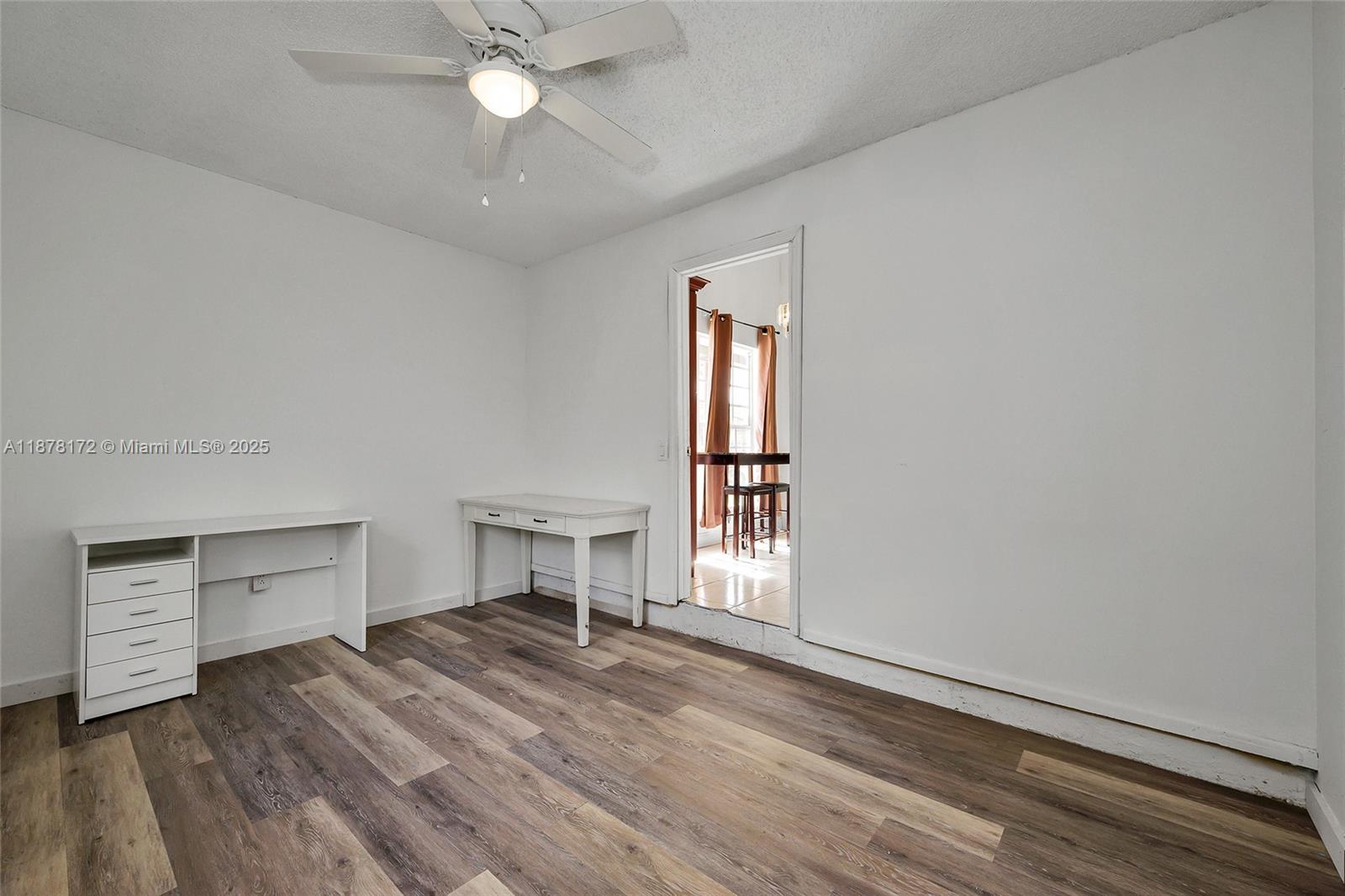 1720 Southwest 84th Avenue Miramar, FL 33025 - Photo 9 of 30 wooden floor in an empty room with a window