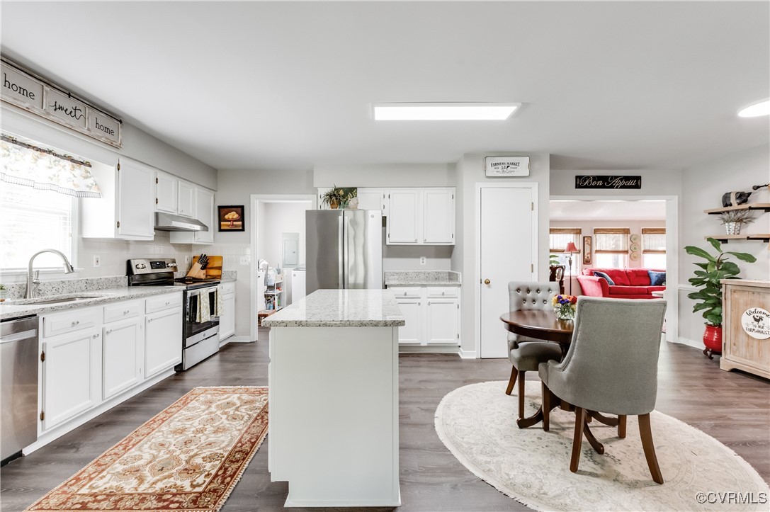 7111 Ledo Road Moseley, VA 23120 - Photo 11 of 47 a living room with furniture and a dining table with kitchen appliances