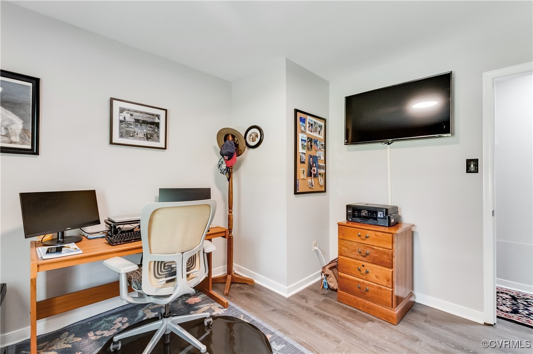 7111 Ledo Road Moseley, VA 23120 - Photo 15 of 47 a view of a workspace with furniture and a flat screen tv