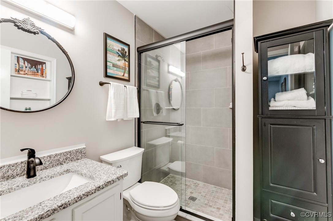 7111 Ledo Road Moseley, VA 23120 - Photo 16 of 47 a bathroom with a granite countertop sink toilet and shower