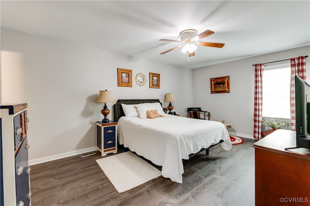 7111 Ledo Road Moseley, VA 23120 - Photo 18 of 47 a bedroom with a bed and a chandelier