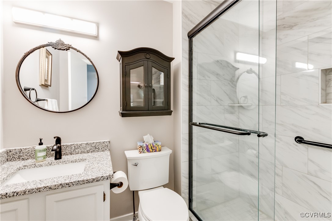 7111 Ledo Road Moseley, VA 23120 - Photo 20 of 47 a bathroom with a toilet a sink and a mirror