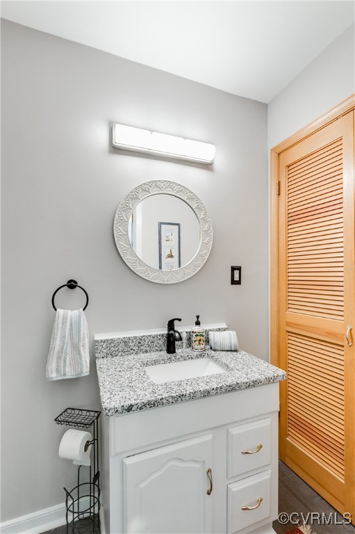 7111 Ledo Road Moseley, VA 23120 - Photo 23 of 47 a bathroom with a granite countertop sink a toilet and a mirror