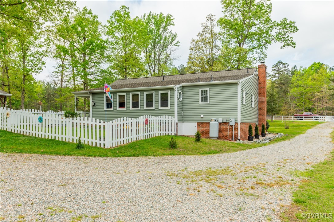 7111 Ledo Road Moseley, VA 23120 - Photo 24 of 47 a front view of a house with a garden and trees