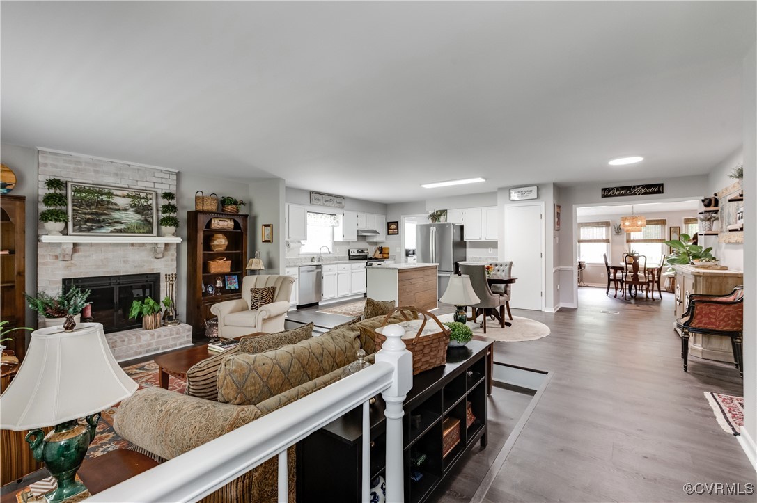 7111 Ledo Road Moseley, VA 23120 - Photo 3 of 47 a living room with fireplace furniture and a view of kitchen