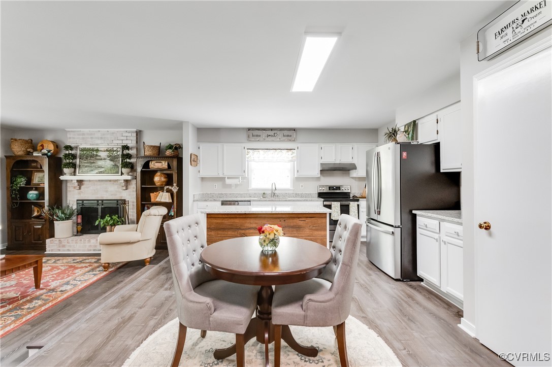 7111 Ledo Road Moseley, VA 23120 - Photo 8 of 47 a living room with furniture a flat screen tv and a refrigerator