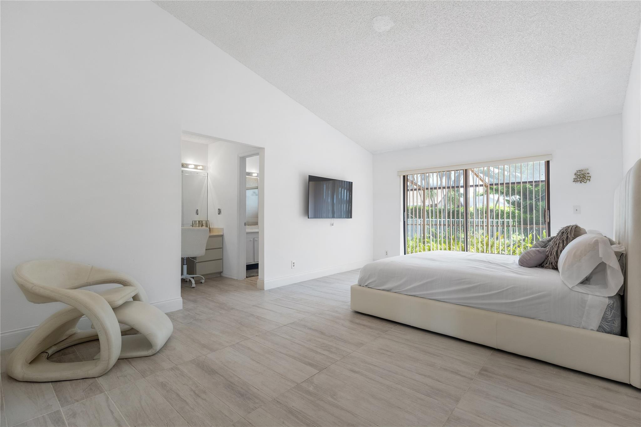 9477 Burlington Place Boca Raton, FL 33434 - Photo 14 of 40 a spacious bedroom with a bed and a couch