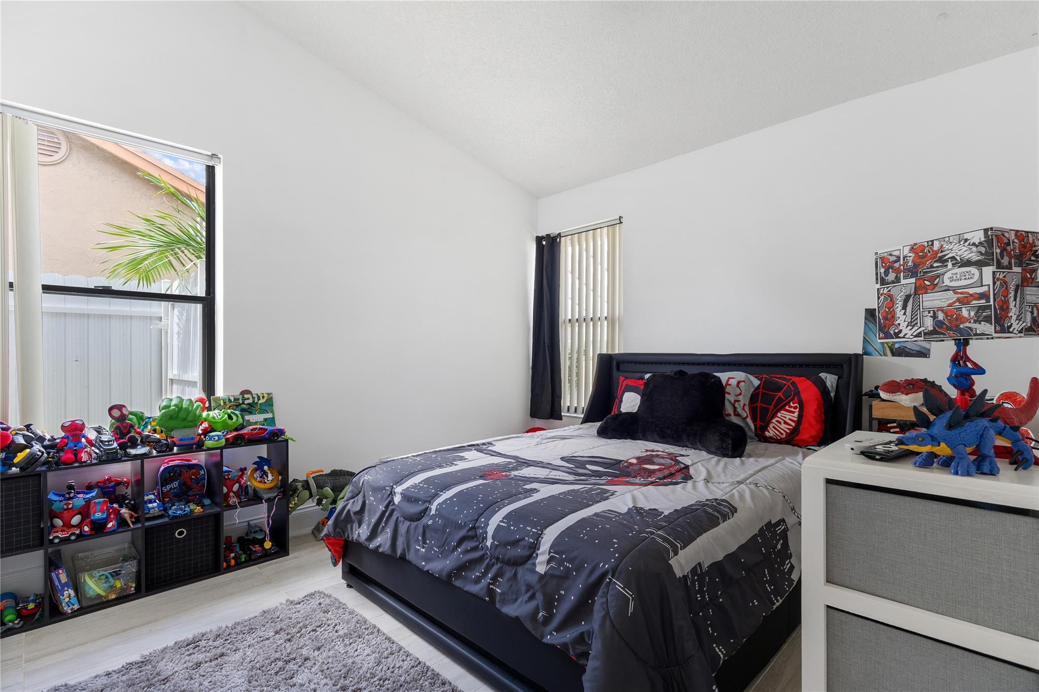 9477 Burlington Place Boca Raton, FL 33434 - Photo 19 of 40 a bedroom with a bed a books dresser and a window