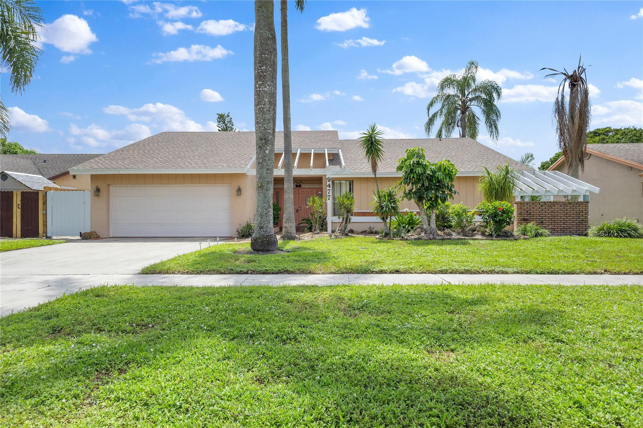 9477 Burlington Place Boca Raton, FL 33434 - Photo 33 of 40 a front view of a house with garden