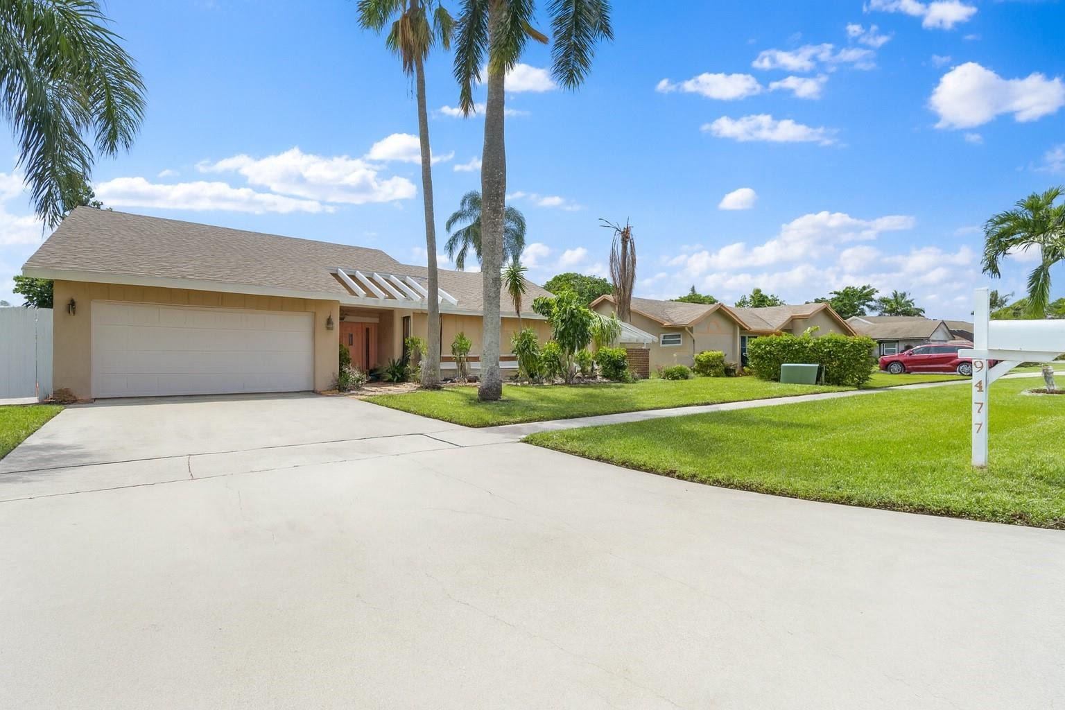 9477 Burlington Place Boca Raton, FL 33434 - Photo 34 of 40 a front view of a house with yard and garden