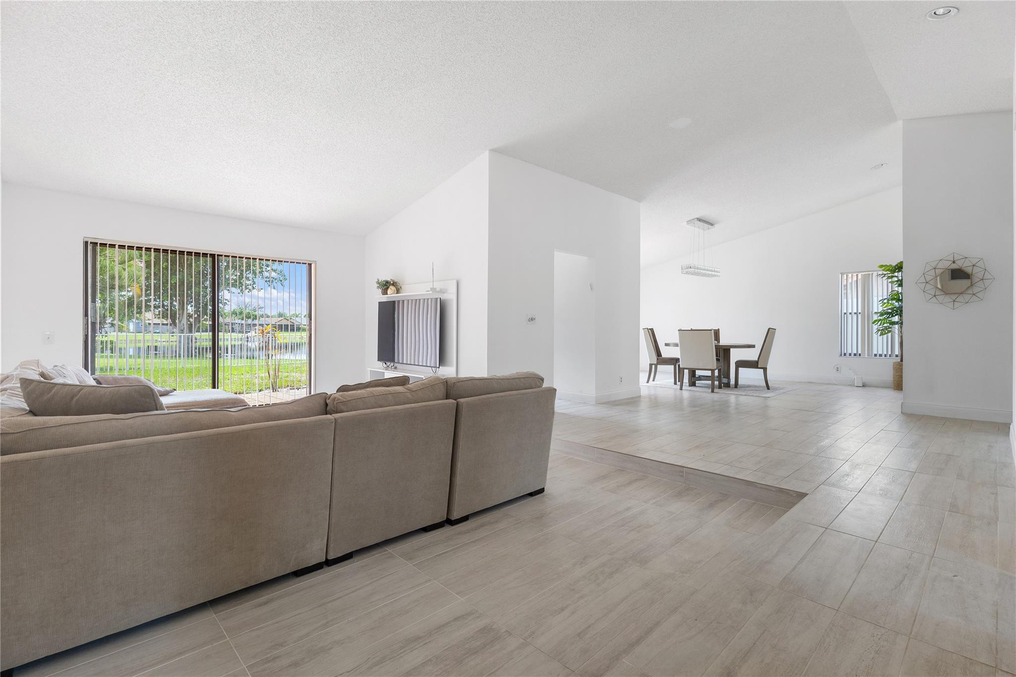 9477 Burlington Place Boca Raton, FL 33434 - Photo 9 of 40 a living room with furniture and a large window