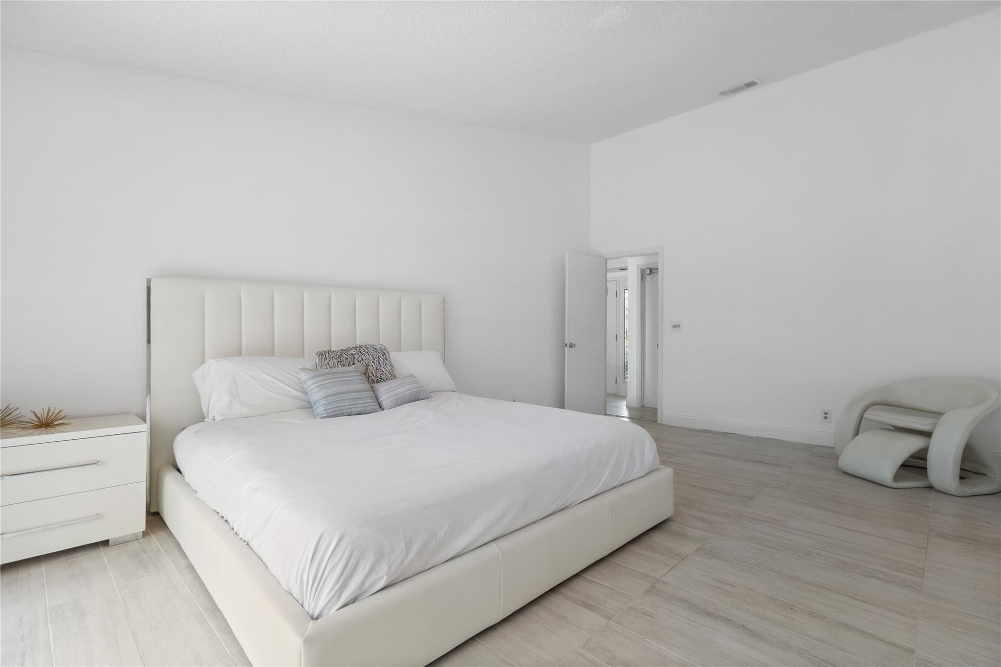 9477 Burlington Place Boca Raton, FL 33434 - Photo 10 of 40 a large bed sitting in a bedroom next to a window