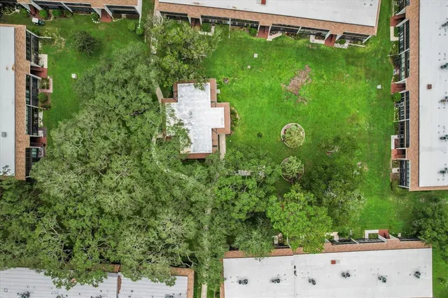 aerial view of a house with a yard and a fountain