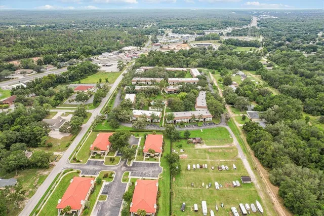 a view of a city with lawn chairs under an umbrella
