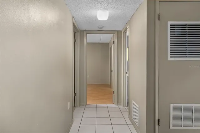 a view of a hallway to rooms and stairs