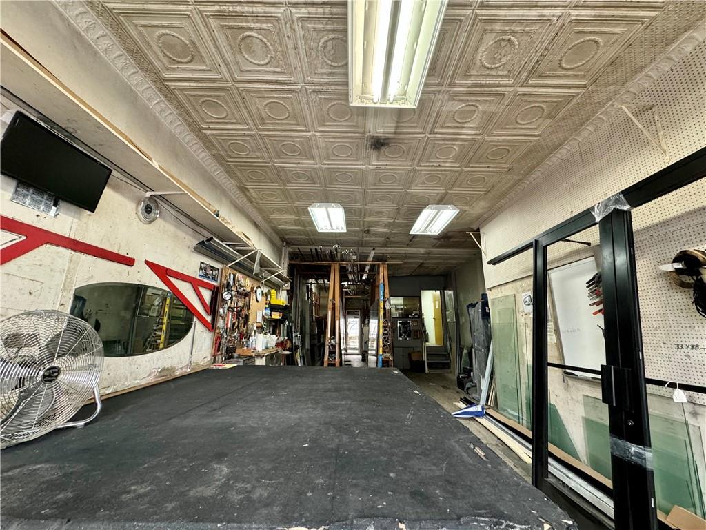 6119 4th Avenue Brooklyn, NY 11220 - Photo 7 of 9 a view of an empty room with wooden floor