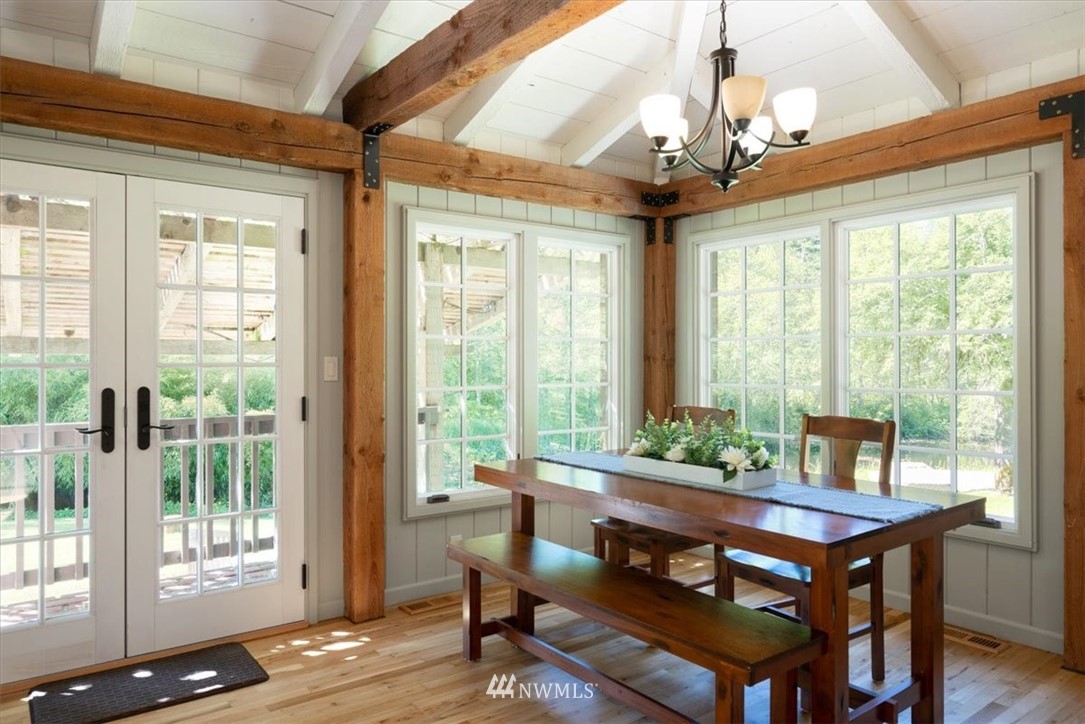 4214 Linnell Road Deming, WA 98244 - Photo 3 of 40 a view of a dining room with furniture wooden floor and chandelier