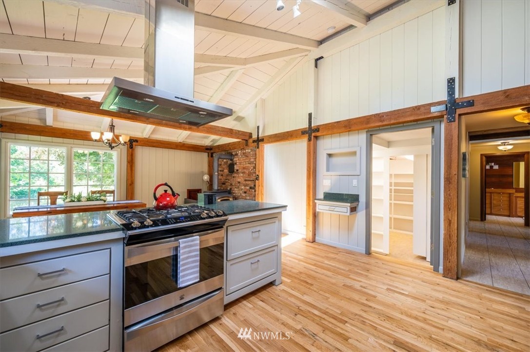 4214 Linnell Road Deming, WA 98244 - Photo 29 of 40 a kitchen with stainless steel appliances granite countertop a stove and a refrigerator