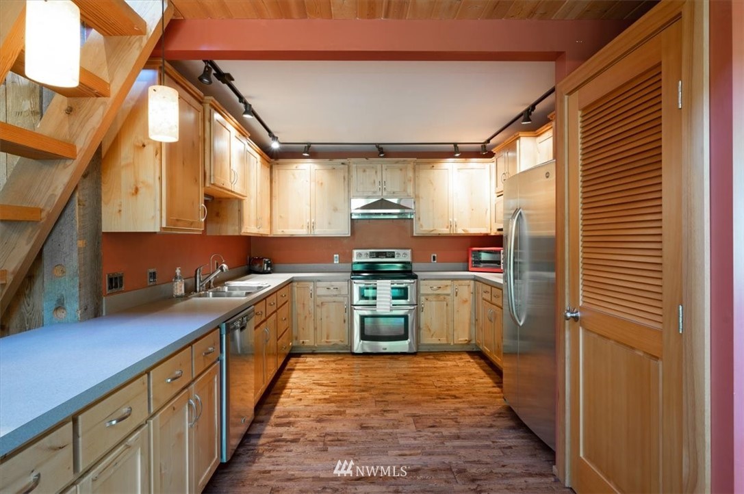 4214 Linnell Road Deming, WA 98244 - Photo 32 of 40 a kitchen with a sink cabinets stainless steel appliances and a window
