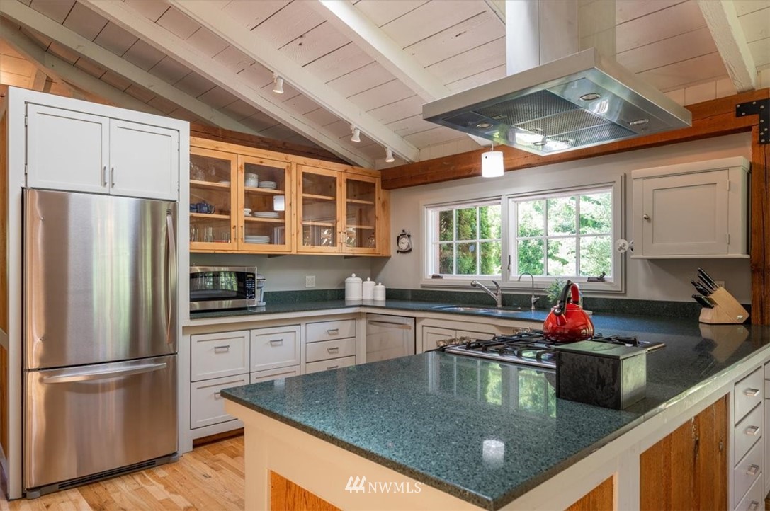 4214 Linnell Road Deming, WA 98244 - Photo 5 of 40 a kitchen with stainless steel appliances granite countertop a sink dishwasher a refrigerator and cabinets with wooden floor