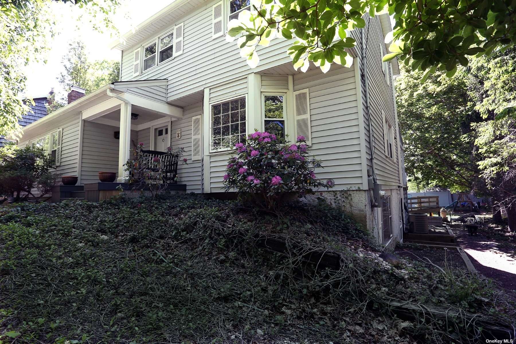 a view of a house with a yard and tree s