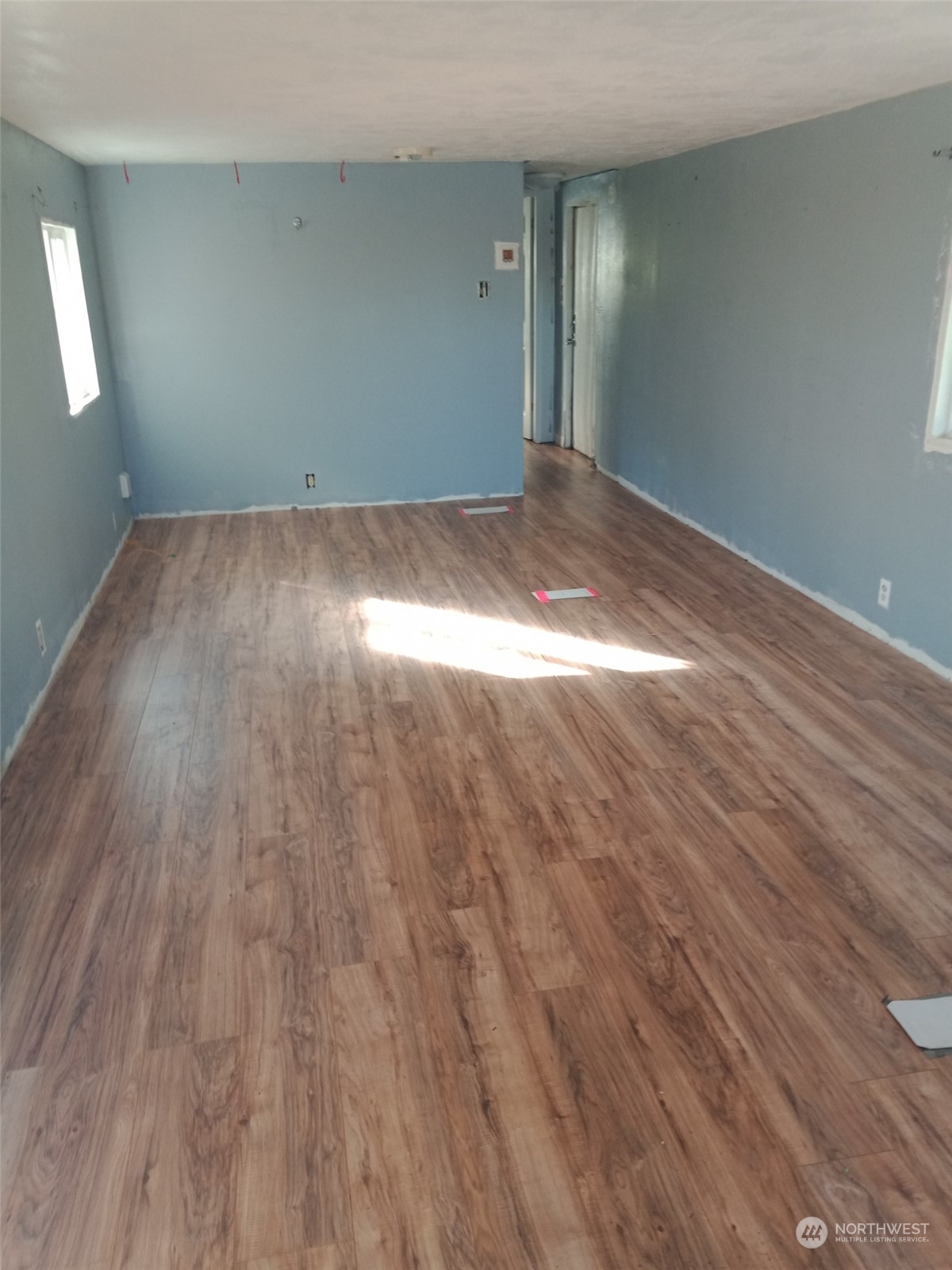 11903 State Game Road Eatonville, WA 98328 - Photo 16 of 24 an empty room with wooden floor and windows