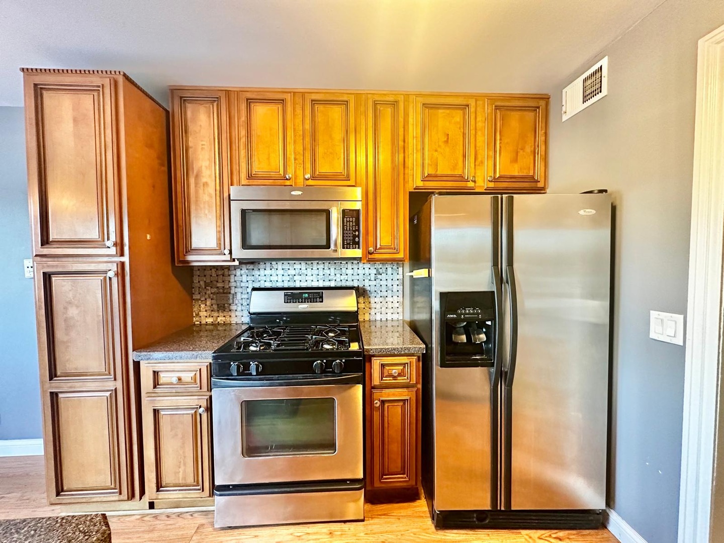 575 Greystone Lane, Unit A2 Wheeling, IL 60090 - Photo 2 of 13 a kitchen with stainless steel appliances a refrigerator stove and microwave