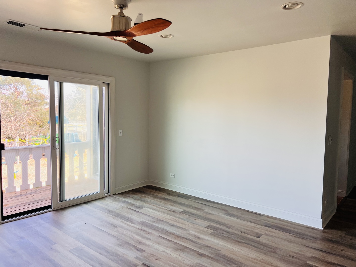 575 Greystone Lane, Unit A2 Wheeling, IL 60090 - Photo 10 of 13 a view of an empty room with wooden floor and a window