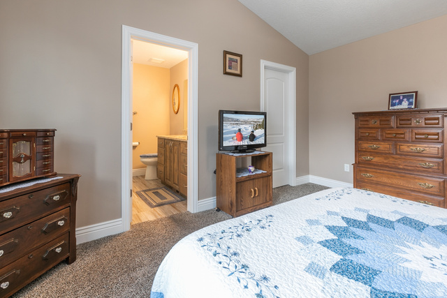 1228 North Providence Way Tooele, UT 84074 - Photo 14 of 28 Carpeted room with vaulted ceiling and an attached bathroom