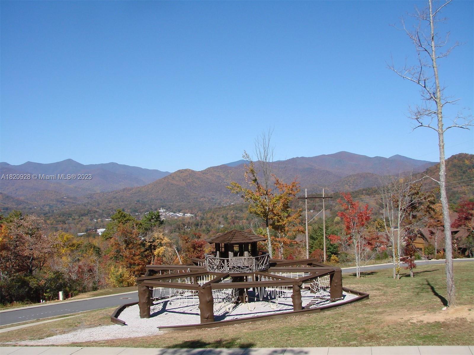 25 Fates Overlook Loop, Unit 103 Black Mountain, NC 28711 - Photo 18 of 21 a view of a lake with a mountain in the background