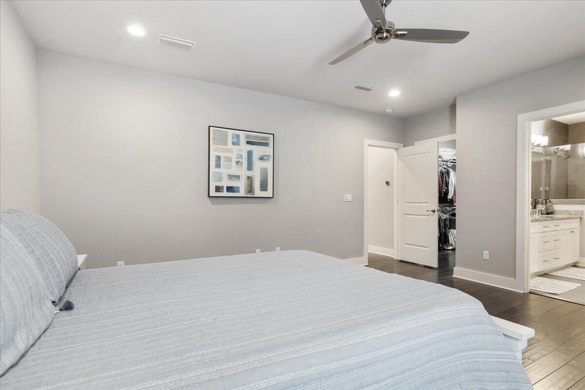 995 Airport Road, Unit 26 Destin, FL 32541 - Photo 20 of 39 a bedroom with a large bed and a chandelier