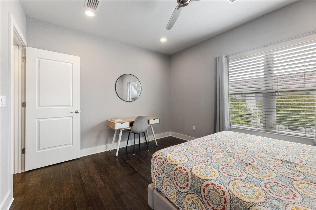 995 Airport Road, Unit 26 Destin, FL 32541 - Photo 26 of 39 a bedroom with a bed a table and chair