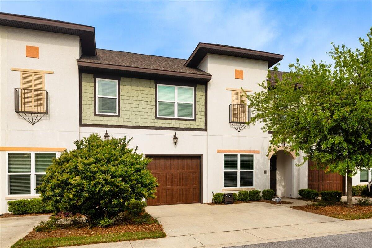 995 Airport Road, Unit 26 Destin, FL 32541 - Photo 3 of 39 a front view of a house with garden