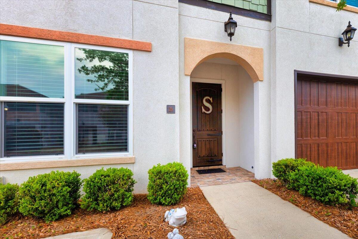 995 Airport Road, Unit 26 Destin, FL 32541 - Photo 6 of 39 a front view of a house with garden