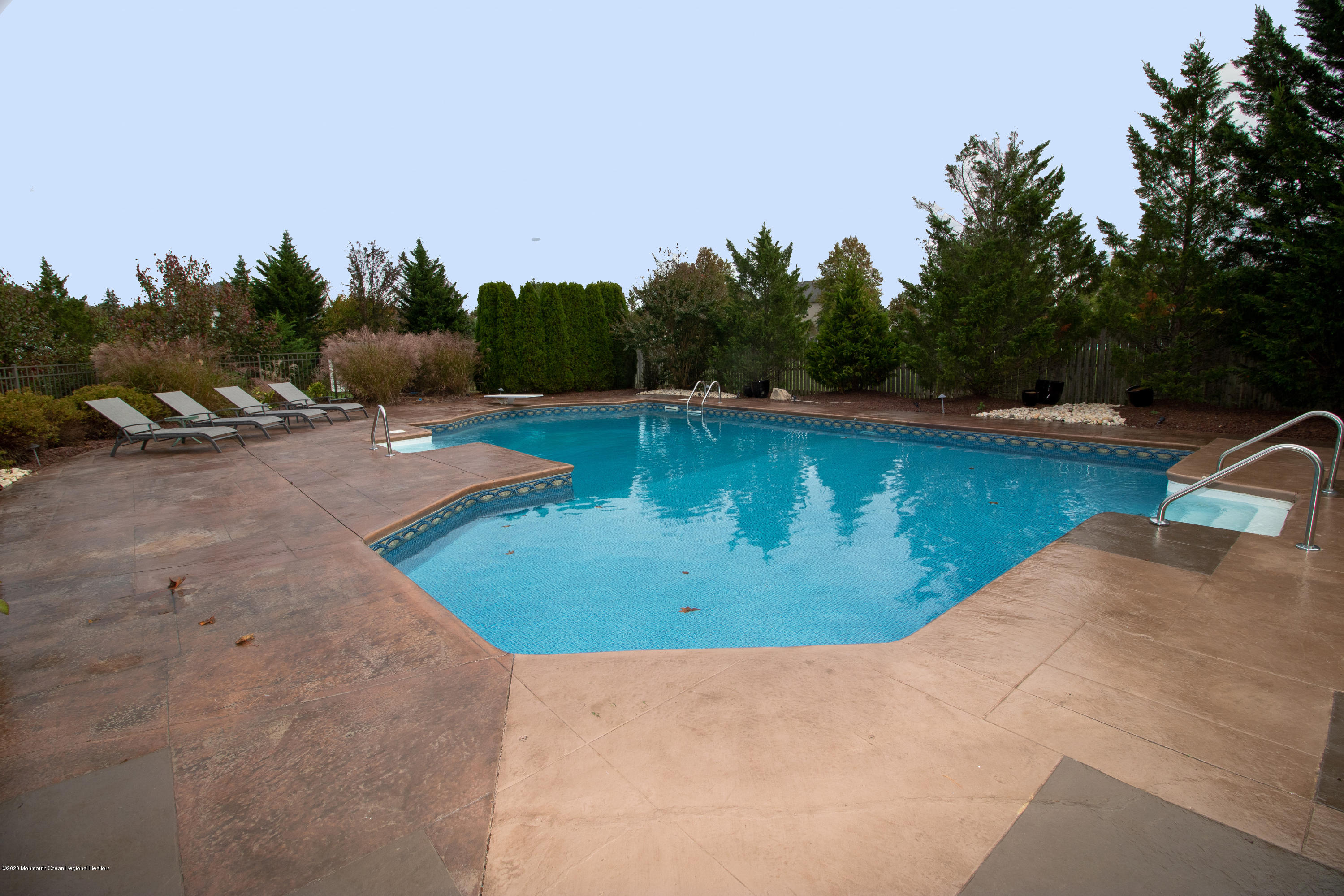 31 Rustic Way Freehold, NJ 07728 - Photo 54 of 62 a view of a swimming pool with seating area and trees in the back