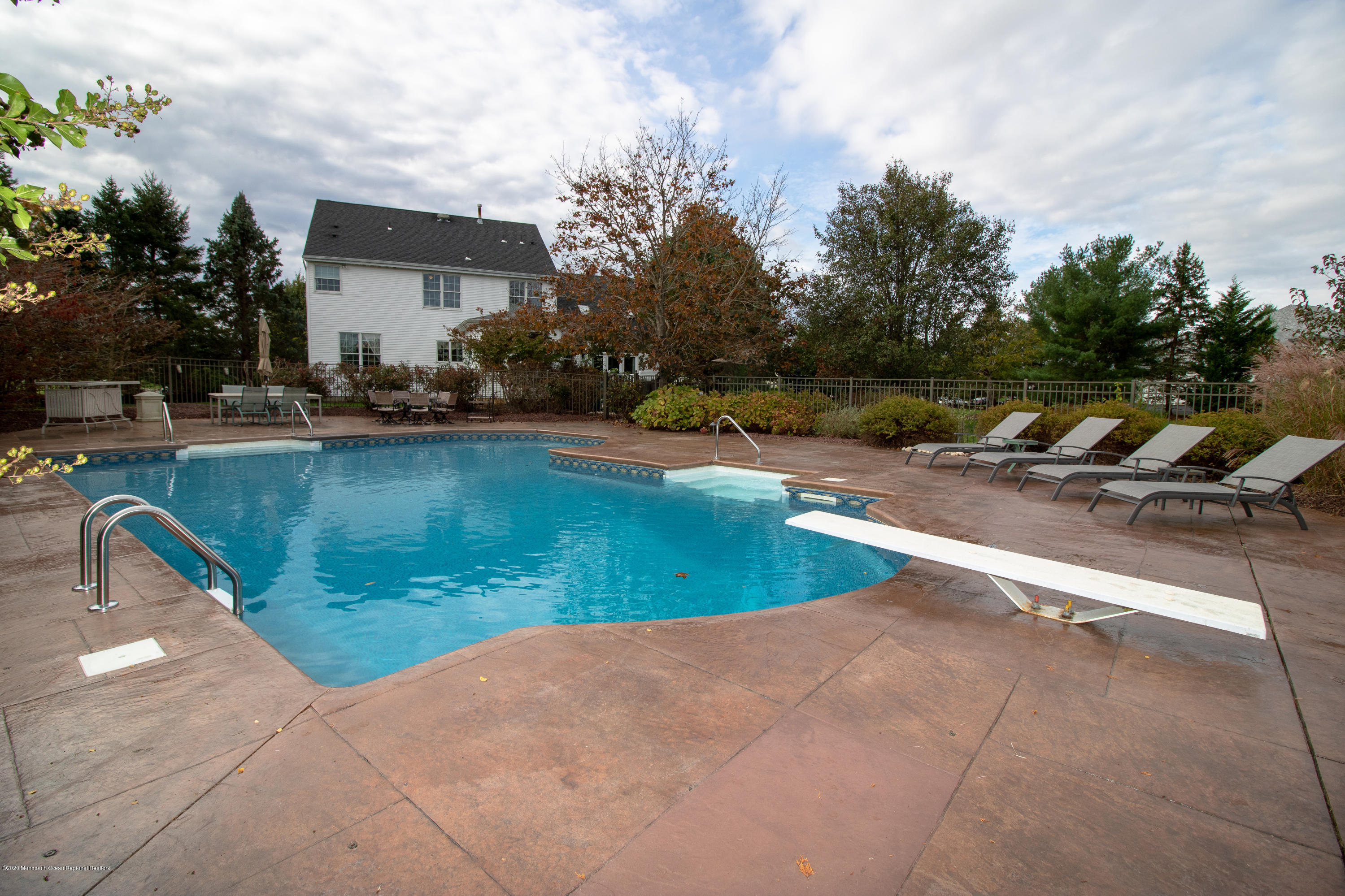 31 Rustic Way Freehold, NJ 07728 - Photo 55 of 62 a view of a swimming pool with a lounge chairs
