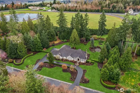 an aerial view of a houses with outdoor space and lake view