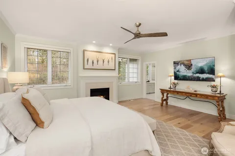 a spacious bedroom with a bed and a flat screen tv