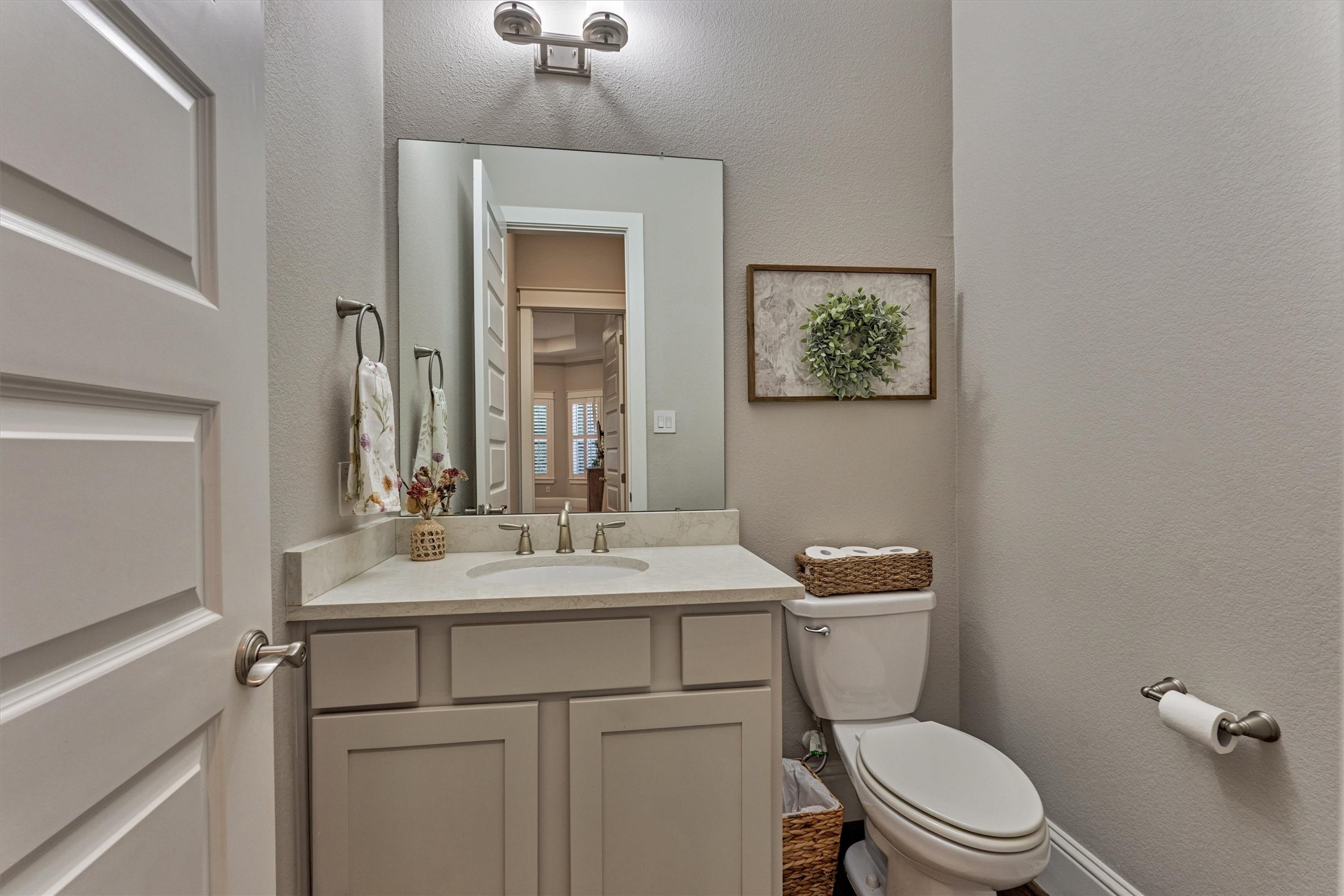 2227 Blue Duck Lane Conroe, TX 77384 - Photo 22 of 50 a bathroom with a toilet sink vanity and mirror