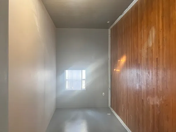 a bathroom with a window and a shower